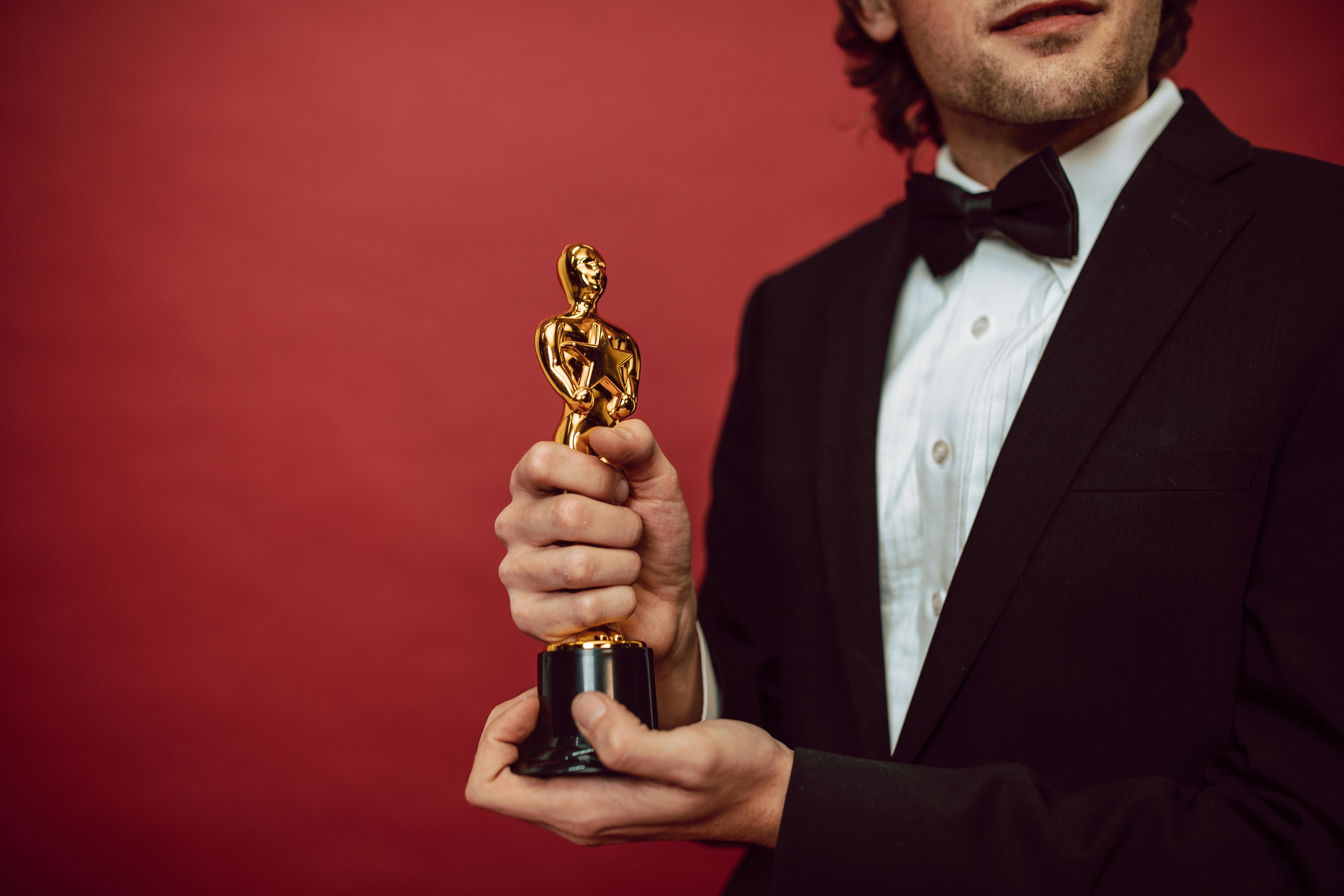 A well dresssed man Holding an Award