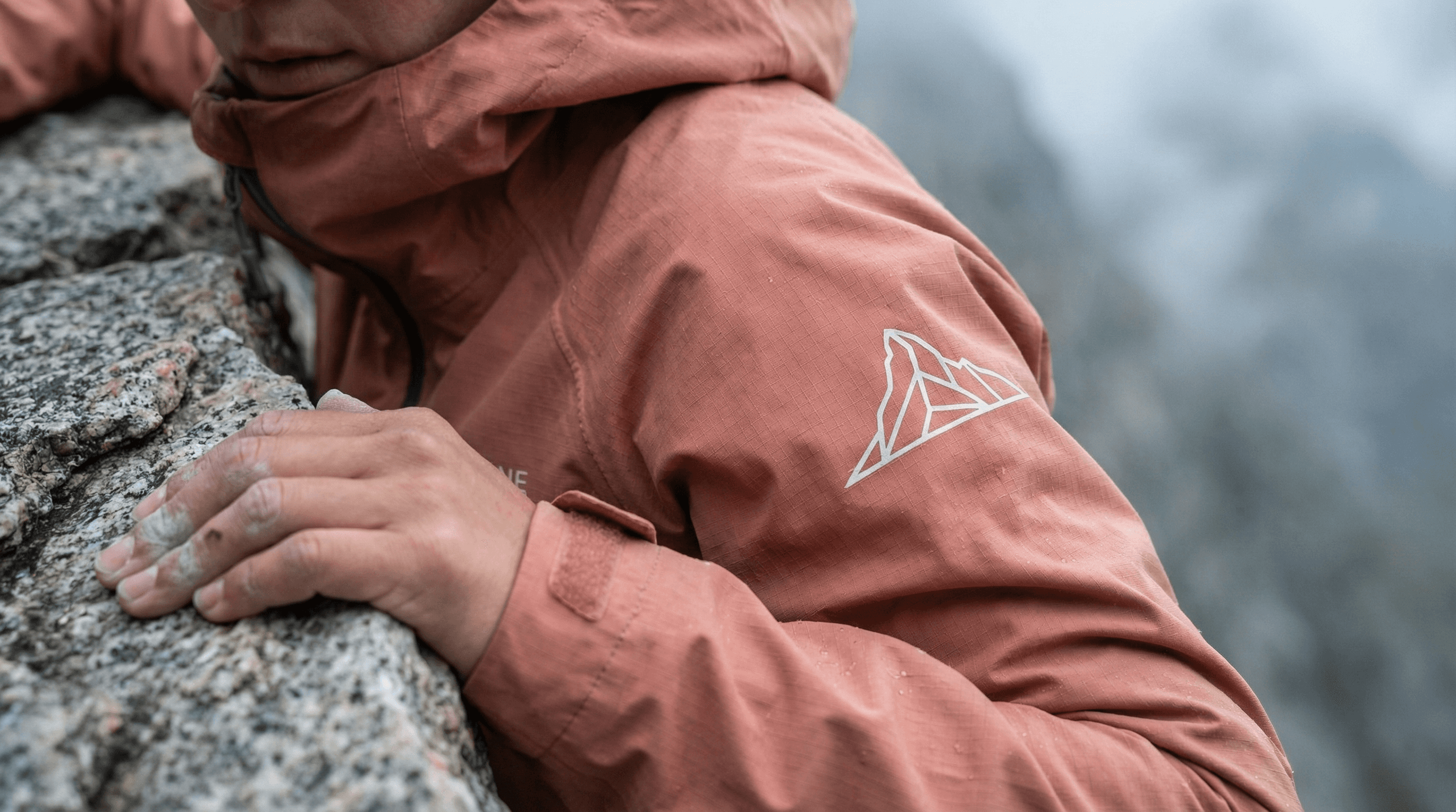 Close-up of an ALPHALINE jacket sleeve during a mountain climb
