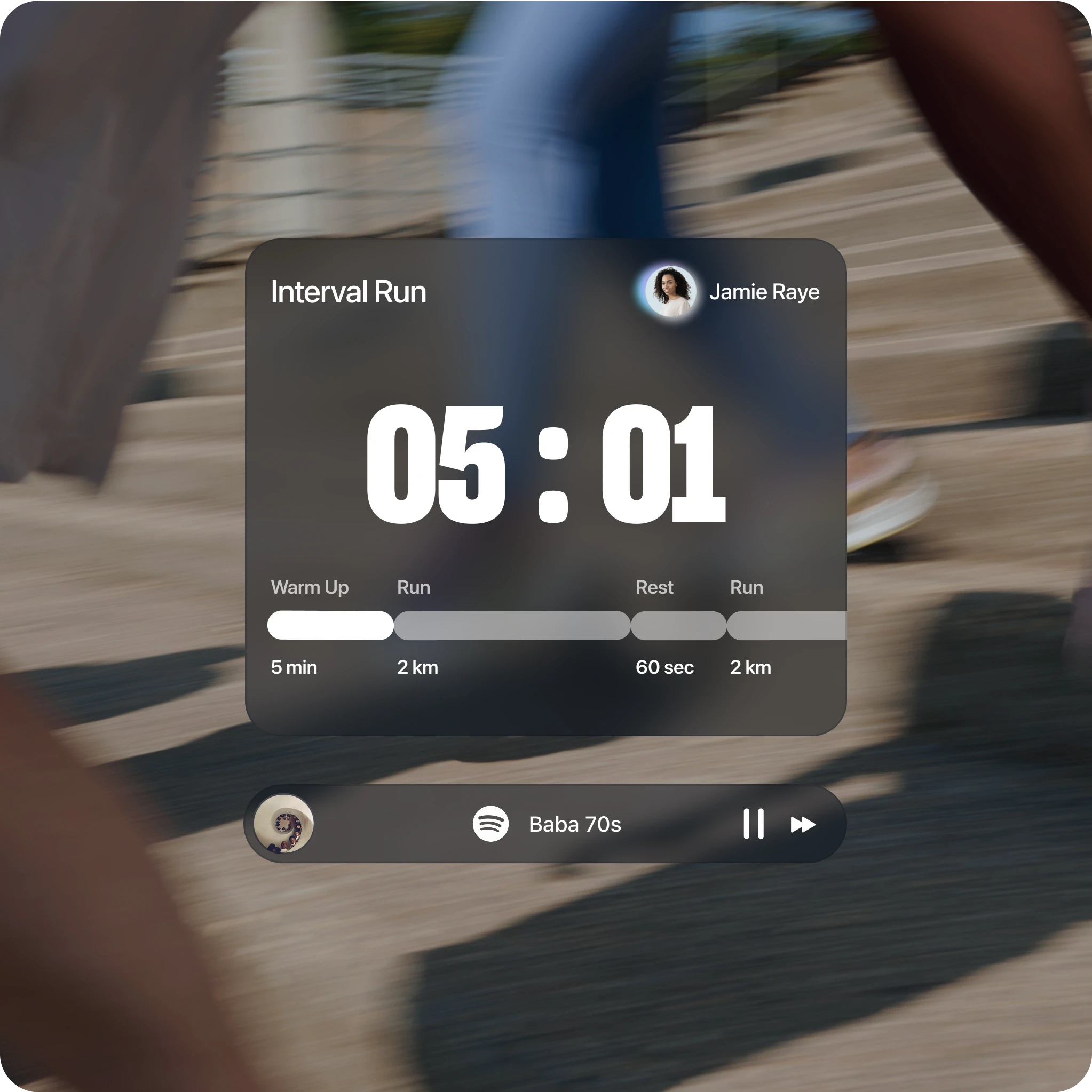 Blurred background of people running on outdoor stairs with a centered overlay displaying an interval run timer. The timer reads "05:01" and is labeled with the workout title “Interval Run” by Jamie Raye. Below the timer is a progress bar with warm-up, run, rest, and run segments: 5 min warm-up, 2 km run, 60 sec rest, 2 km run. At the bottom, a music player shows “Baba 70s” playing via Spotify.