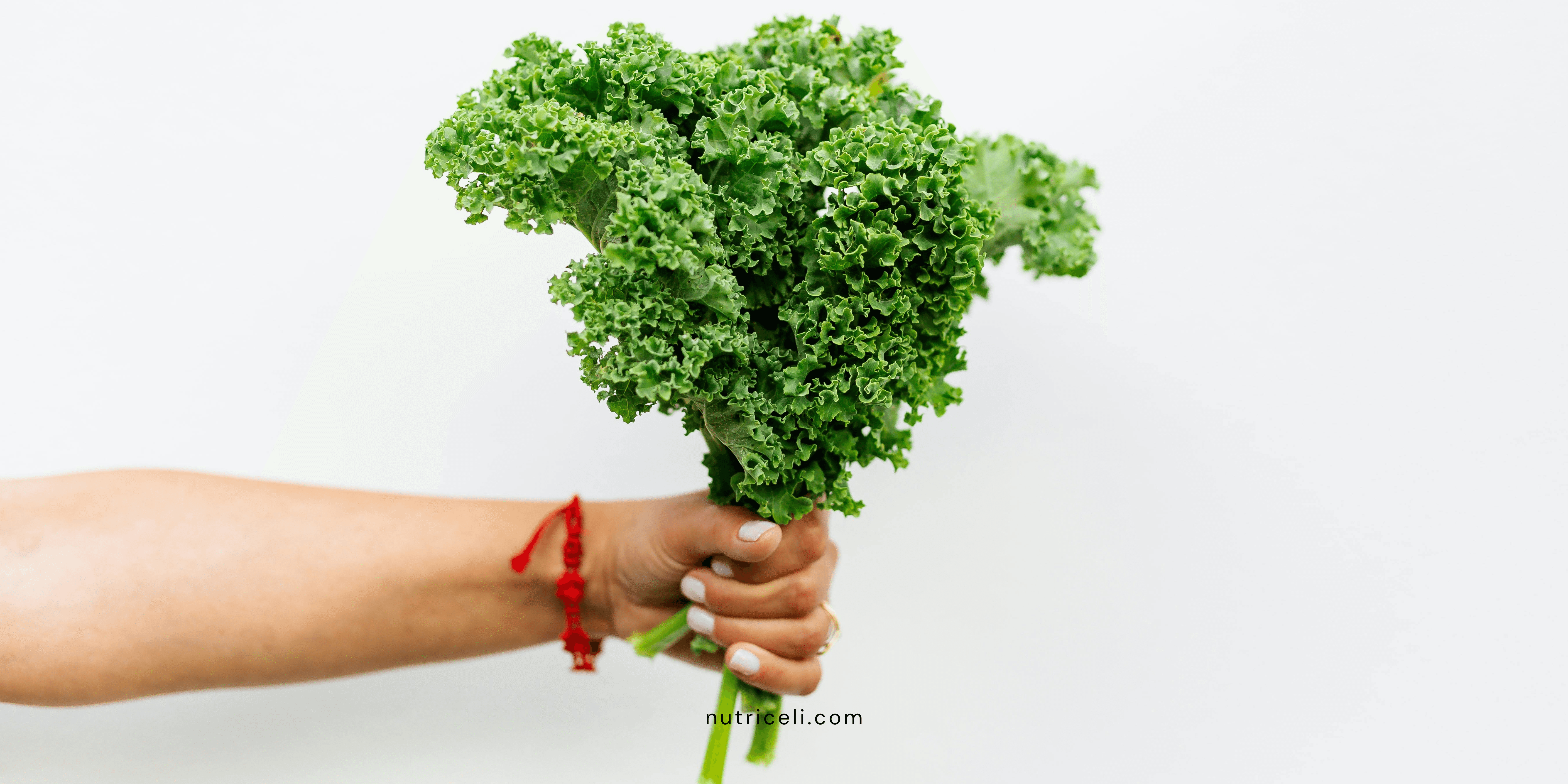 Black woman sitting on a blue couch smiling at her computer screen with her hand out.