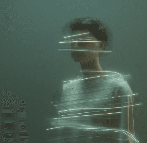 A person stands against a green background, surrounded by dynamic, blurred streaks of white light, creating a futuristic and ethereal atmosphere.