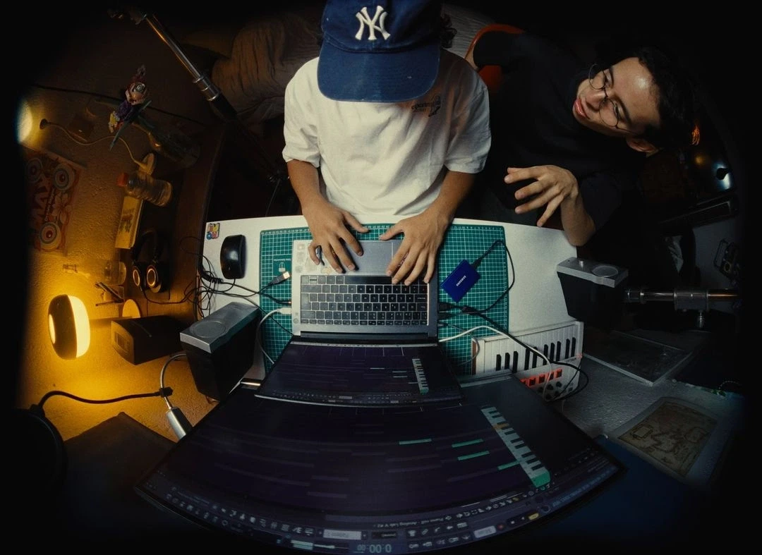 artist on laptop in studio