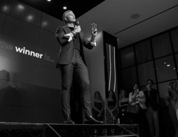 A glowing pyramid emits orange light and crackling blue energy in a dark, surreal environment with a cosmic, futuristic vibe.