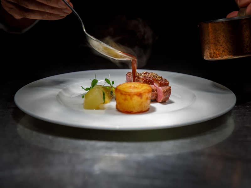 Chef finishing a plated dish at Edition 03