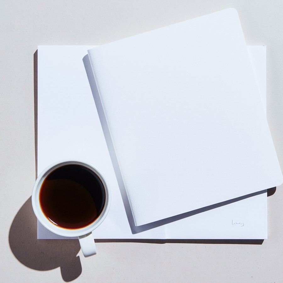 Macro of clear effervescent bubbles in water on a soft gray background—sparkling, minimal texture for clean skincare aesthetic.
