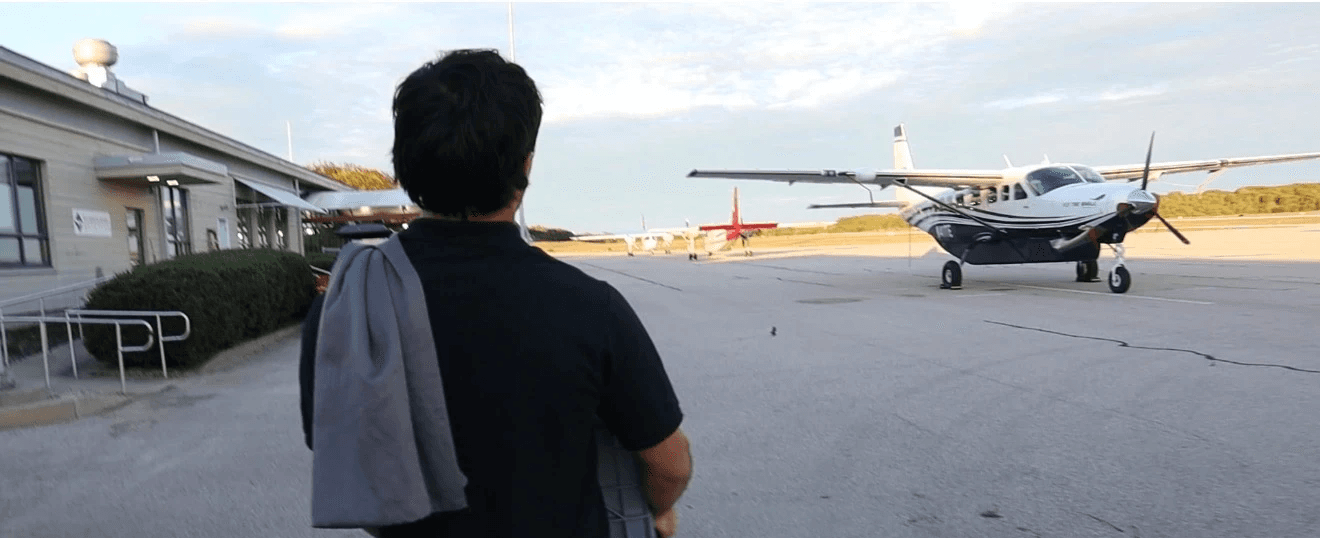 Team of three employees having a meeting at a table in a bright modern office.