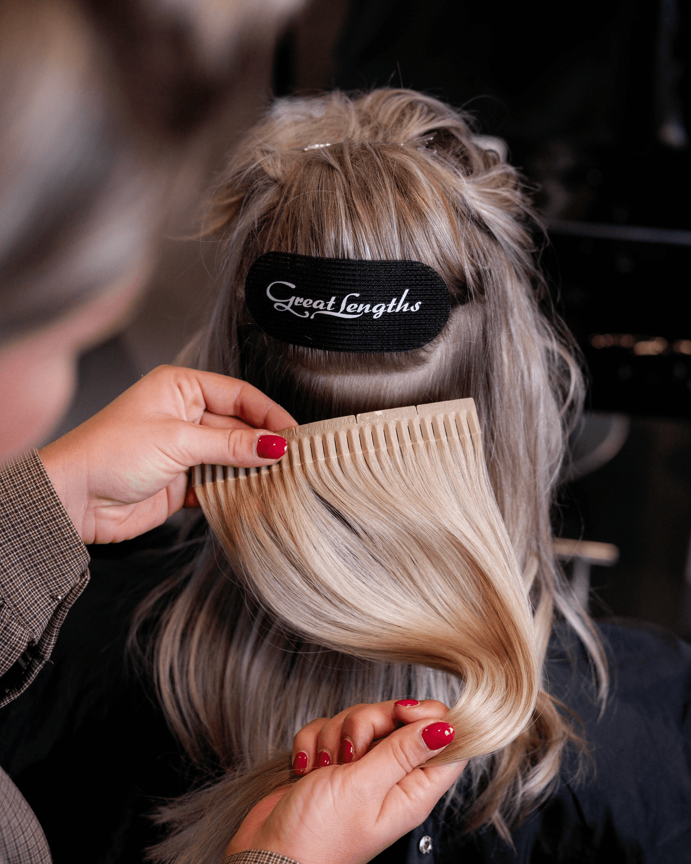 woman in brown long-sleeved top standing beside wall