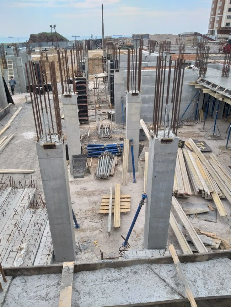 Modern kitchen with a wooden dining table, white chairs, and a hanging light fixture above.