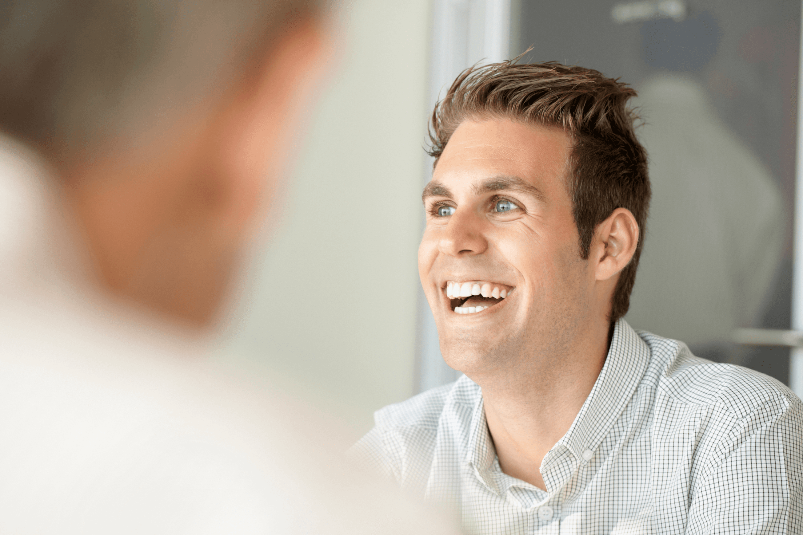 A young male high school student smiling. 