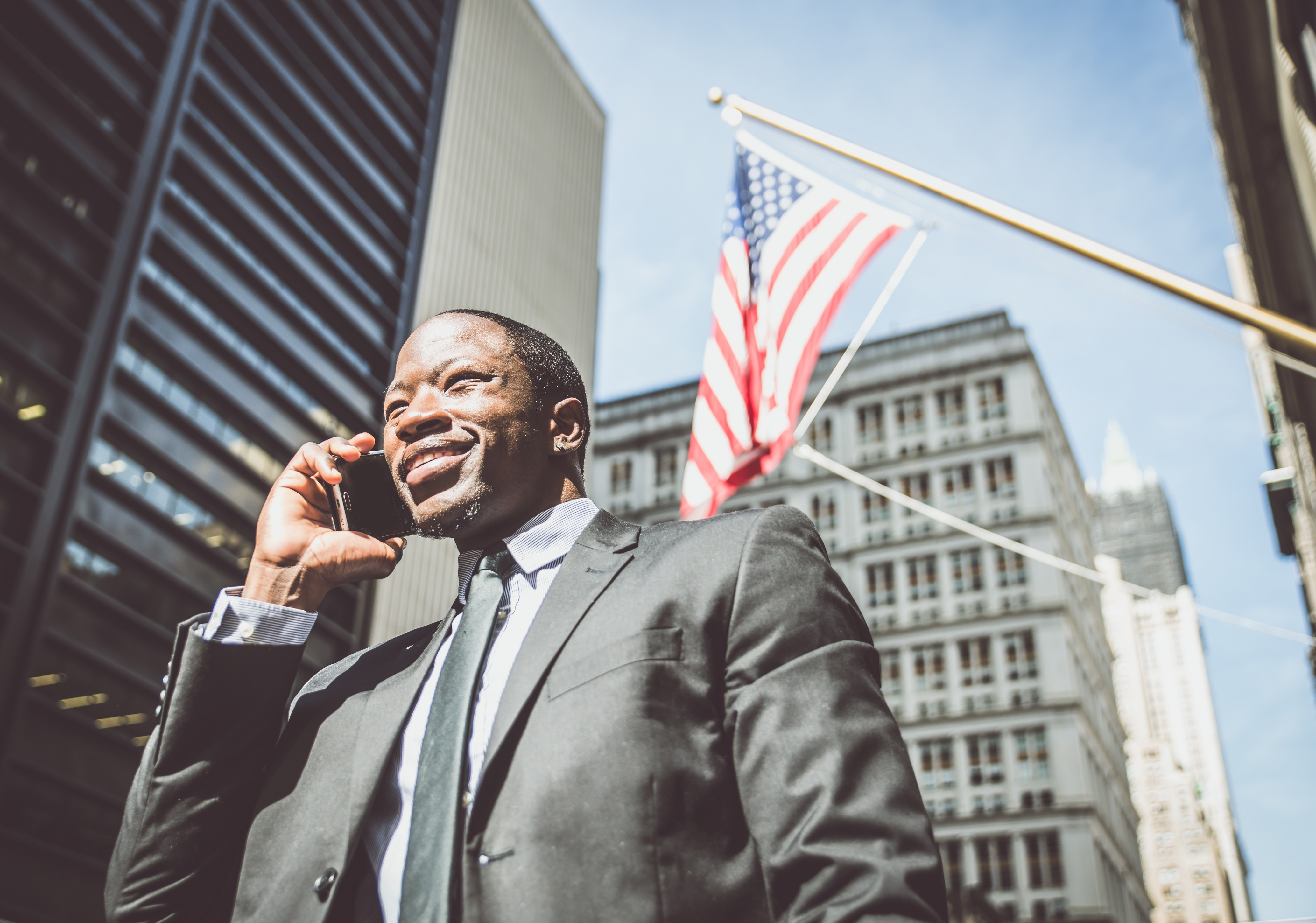 Image of a confident lawyer walking by New York City office building.