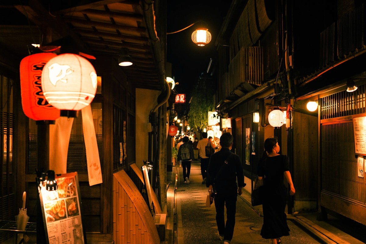 Glowing lanterns along a Kyoto night street in Gion district