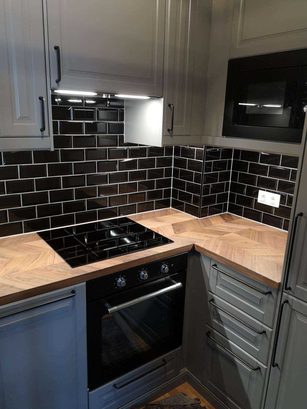 An elegant modern home with balconies, well-lit interiors and surrounded by greenery at dusk.