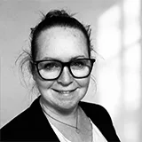 Black and white professional headshot of Christina Brown wearing glasses