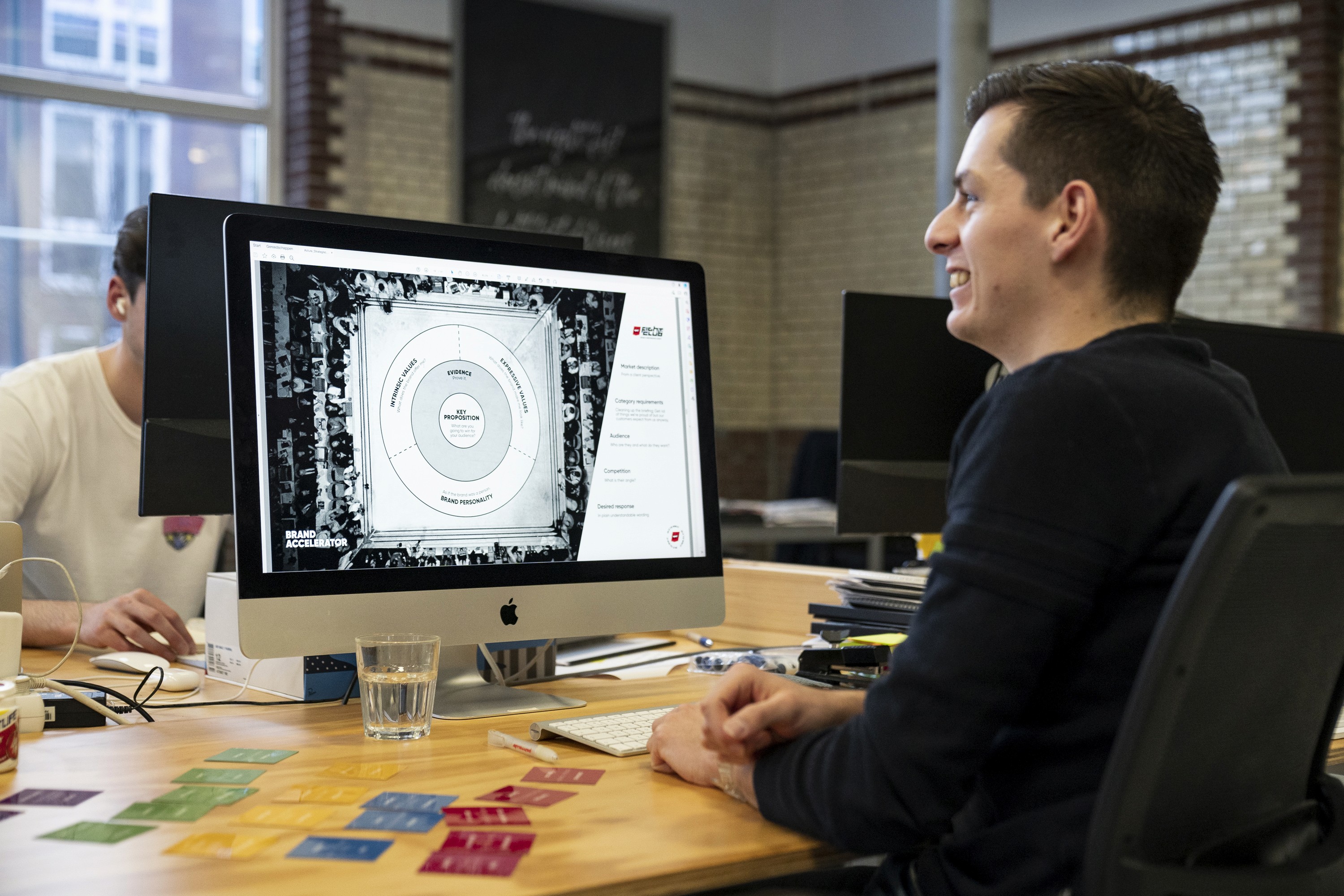 man looks at computer screen with a circular circle with text that is too small for me to read sorry not wearing my glasses