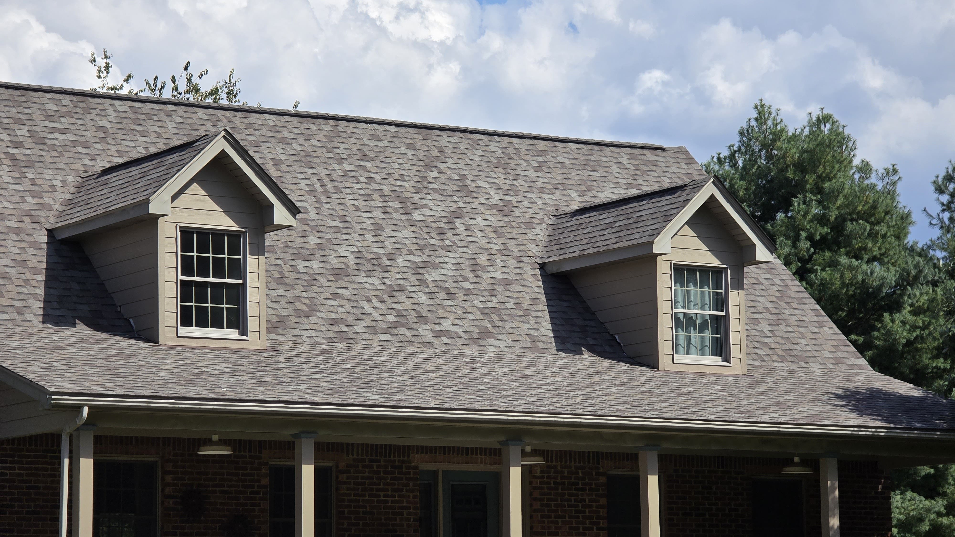 Ground-up view of a residential shingle roof.