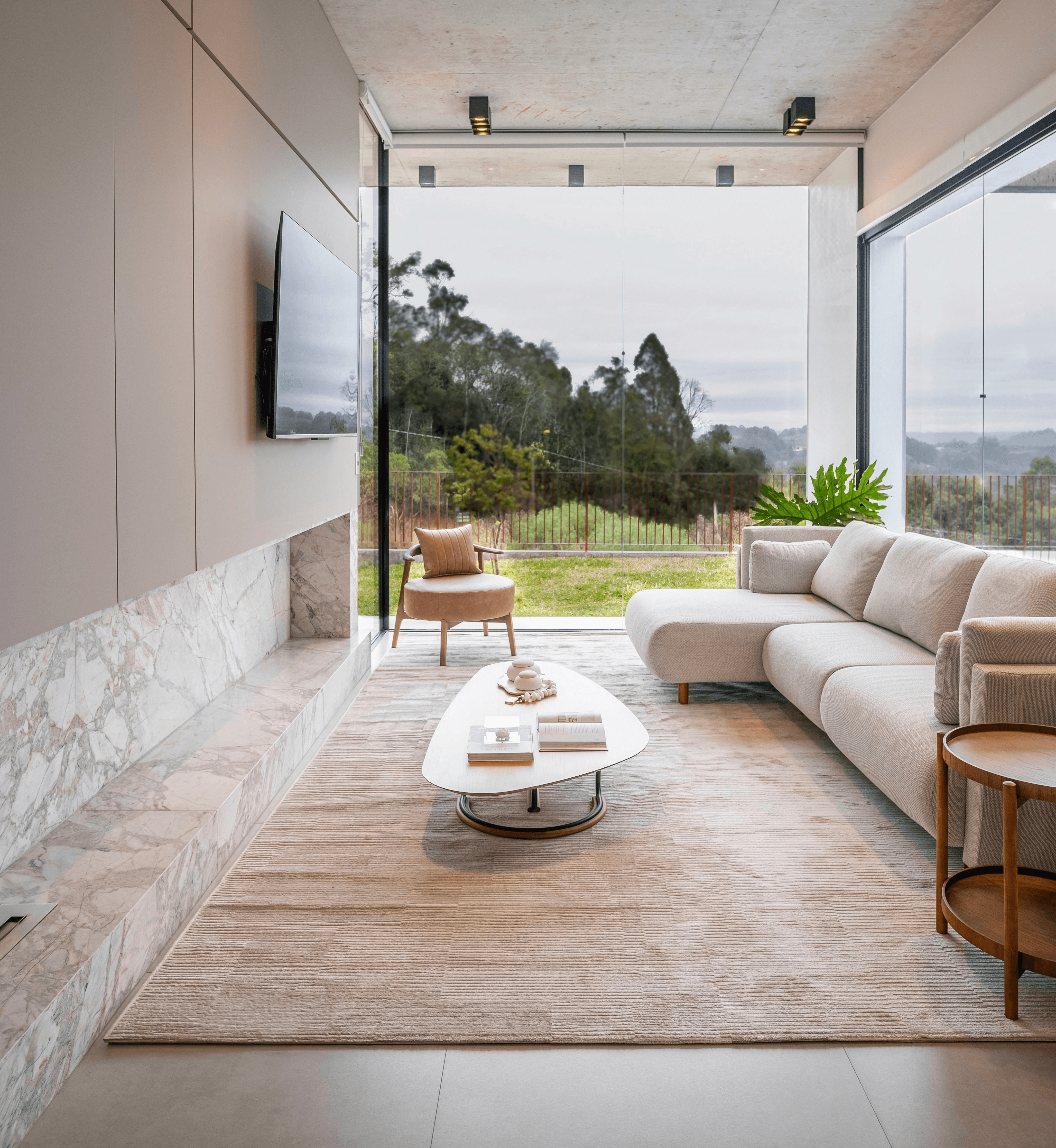 Modern living room with large windows and scenic view.