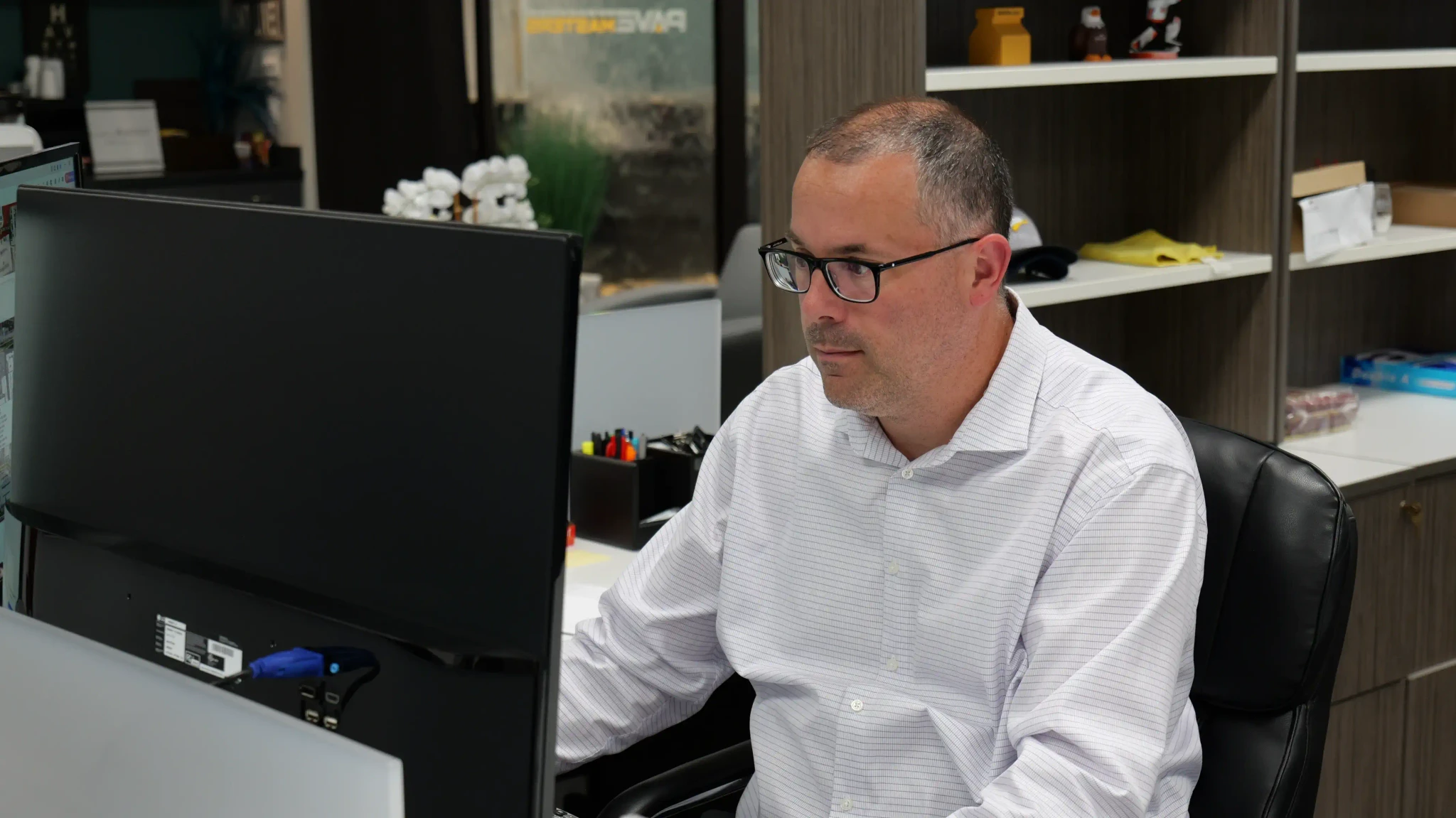 man concentrating at desk typing on computer