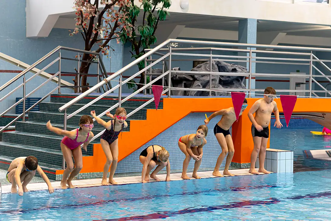 deti skakajici do bazenu