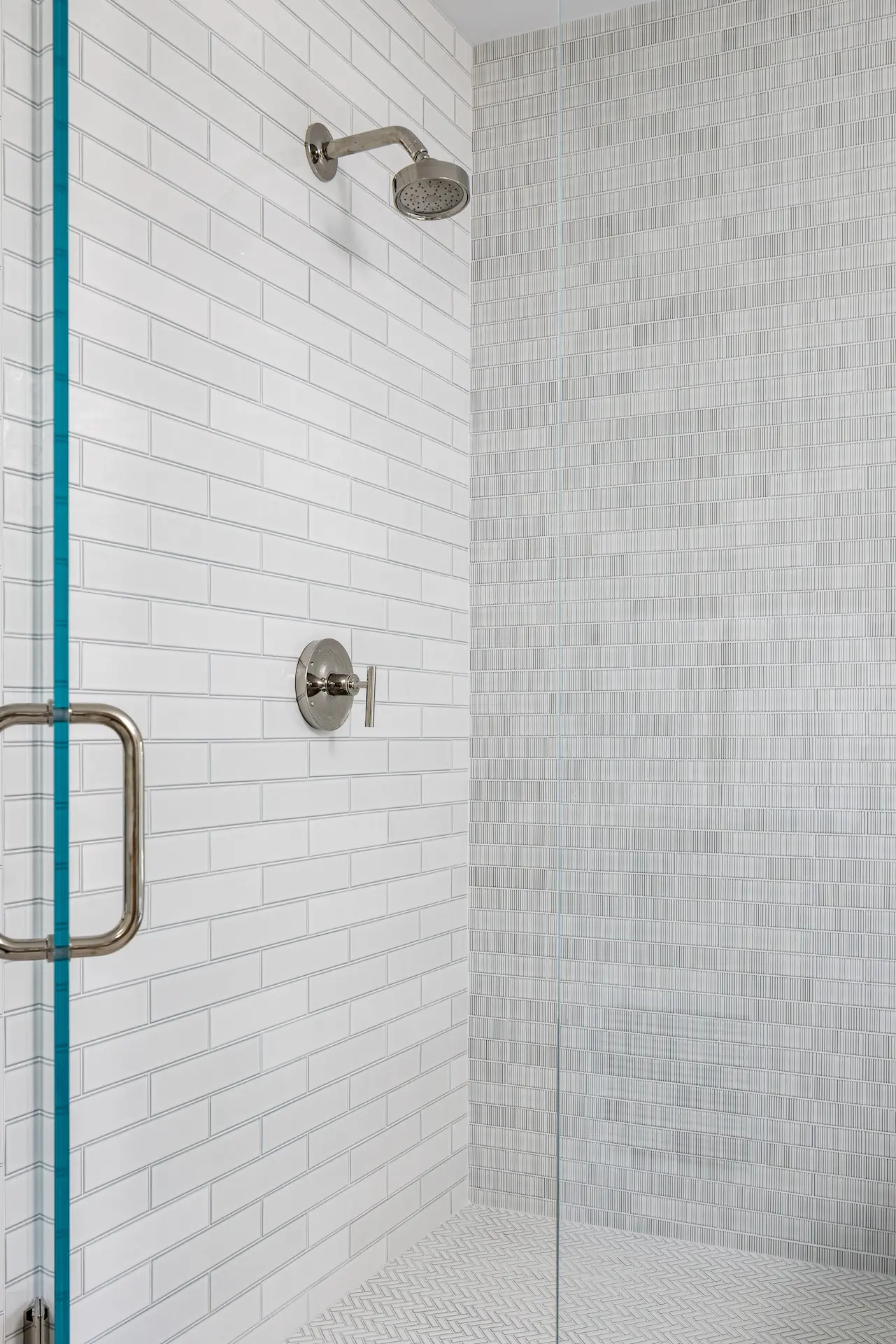 Close-up view of the shower tile in the primary bathroom, showcasing tile details and design in the Irvine Contemporary Coastal Remodel. Photo by Molly Rose Photography.