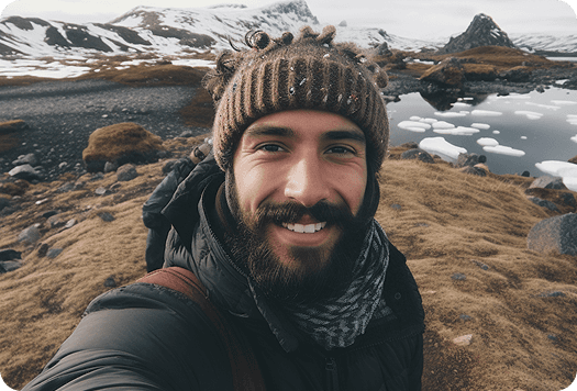 alt="Traveler taking a photo in a scenic mountain location."