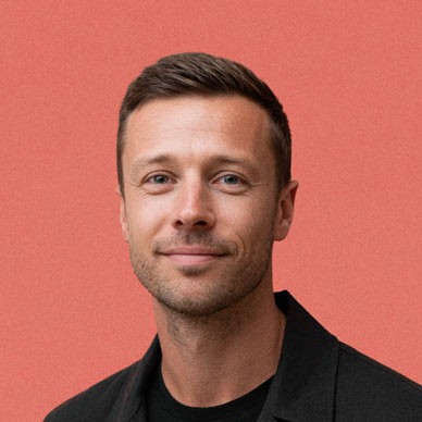 a woman in a black suit and sunglasses