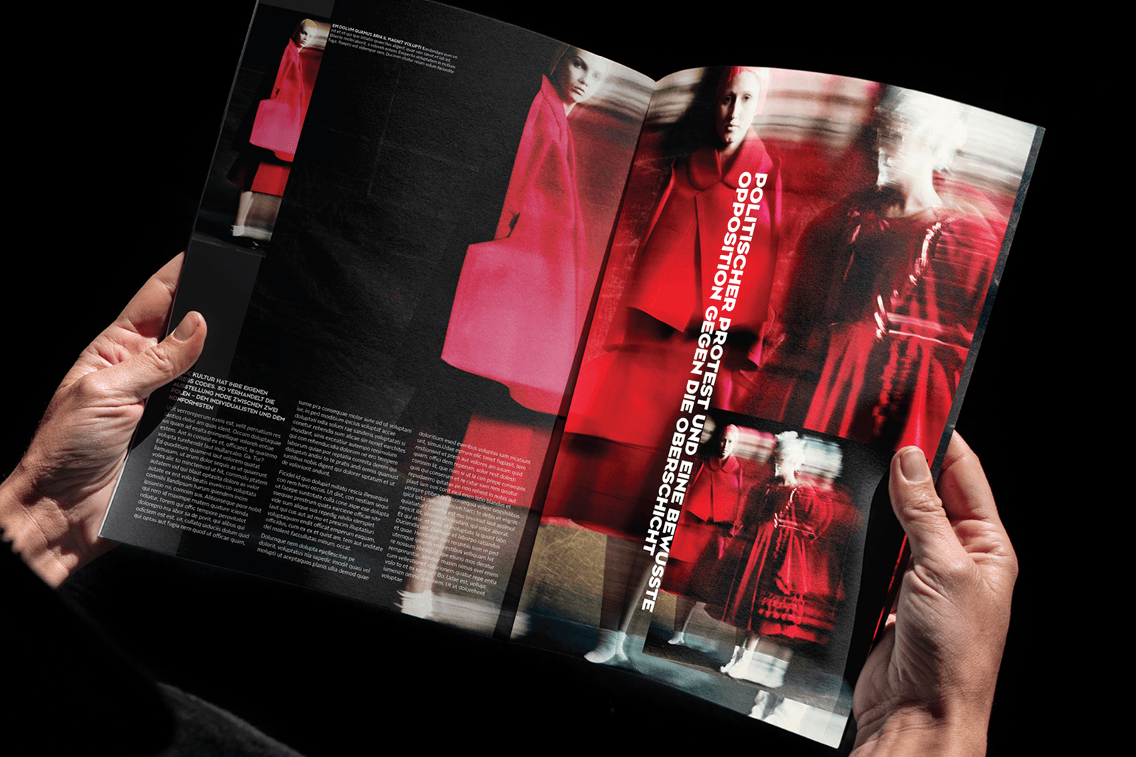 A person holds an open magazine featuring vibrant red graphics and images against a black background.
