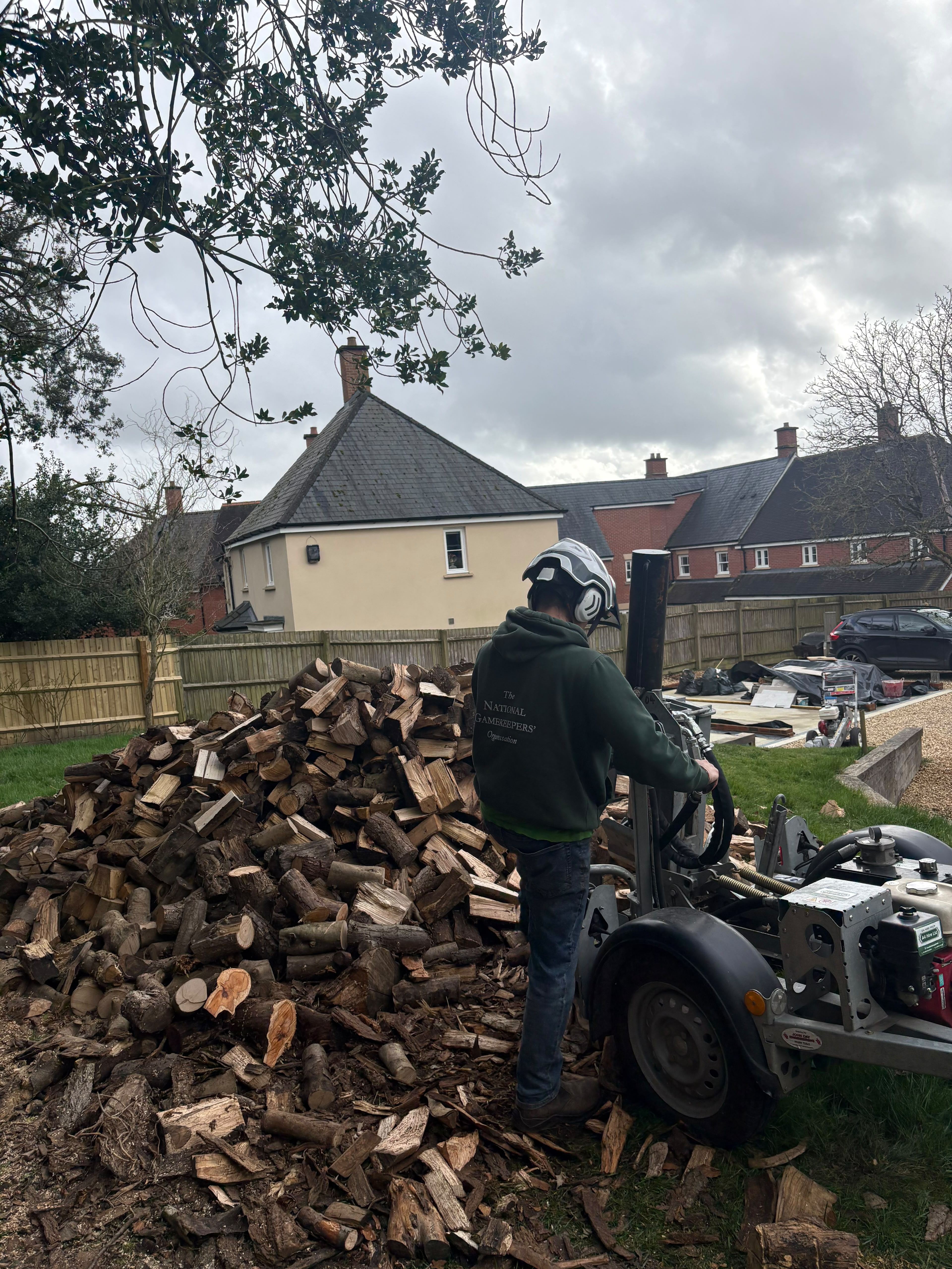 ArborCore log splitter and a large pile of seasoned firewood