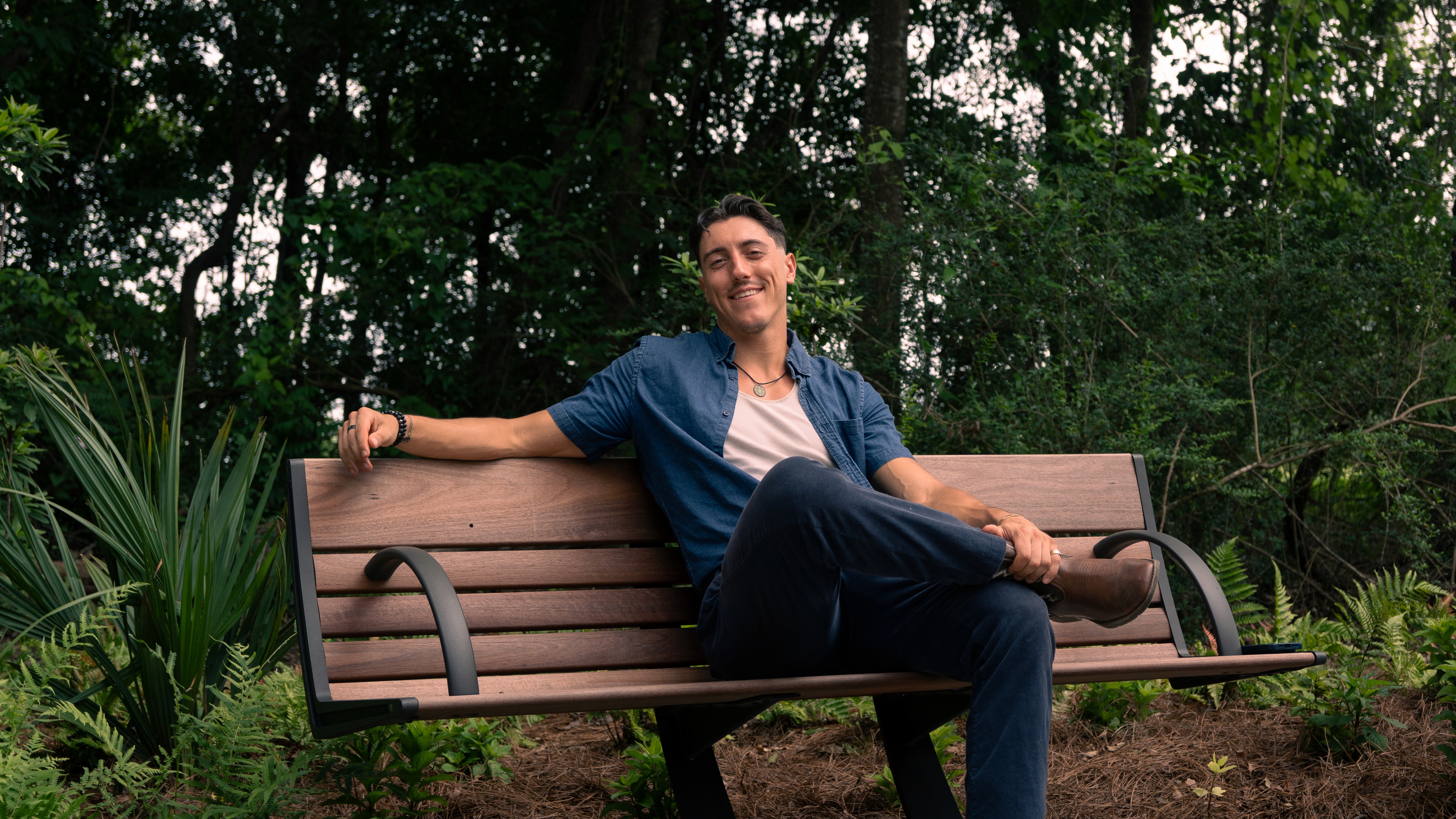 Reese LeBlanc somatic coach relaxed on bench outdoors