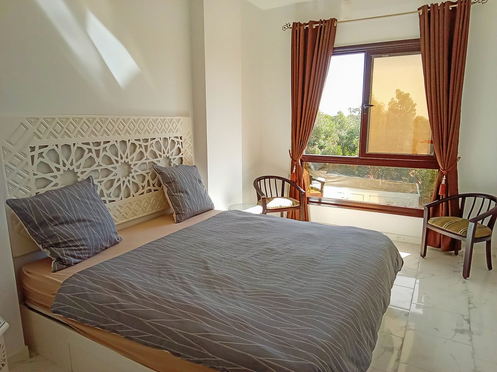 brown wooden house with green grass field