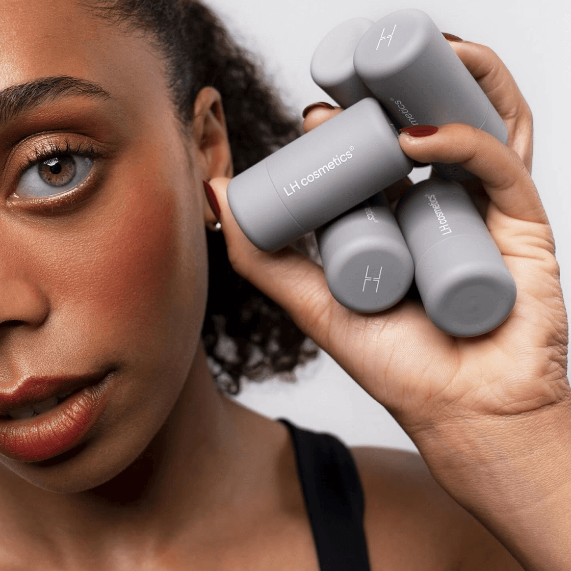 A group of people looking at a laptop and smiling