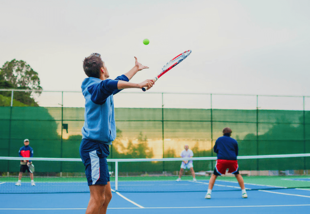 Male tennis player practicing serve technique on a private court in Virginia which is a part of tennis school program