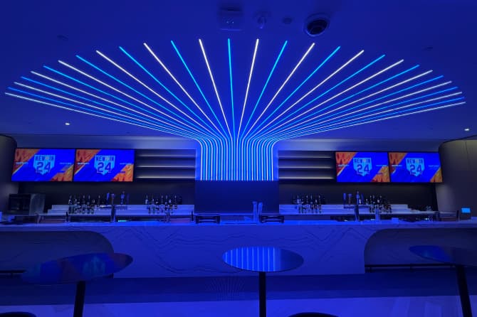 A bar lit with neon lights