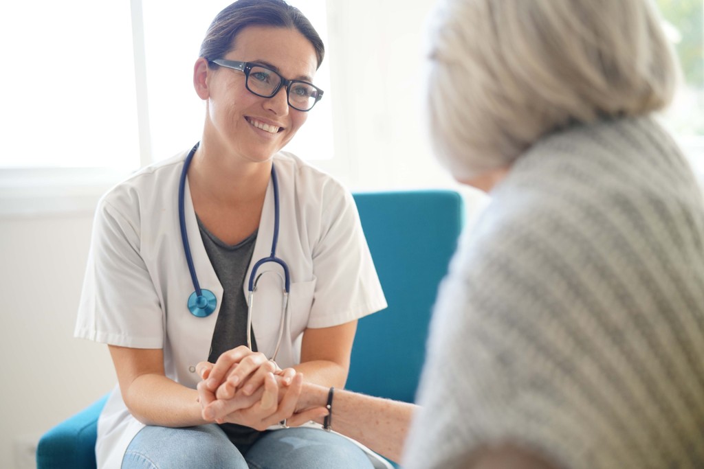 Nurse visiting with patient