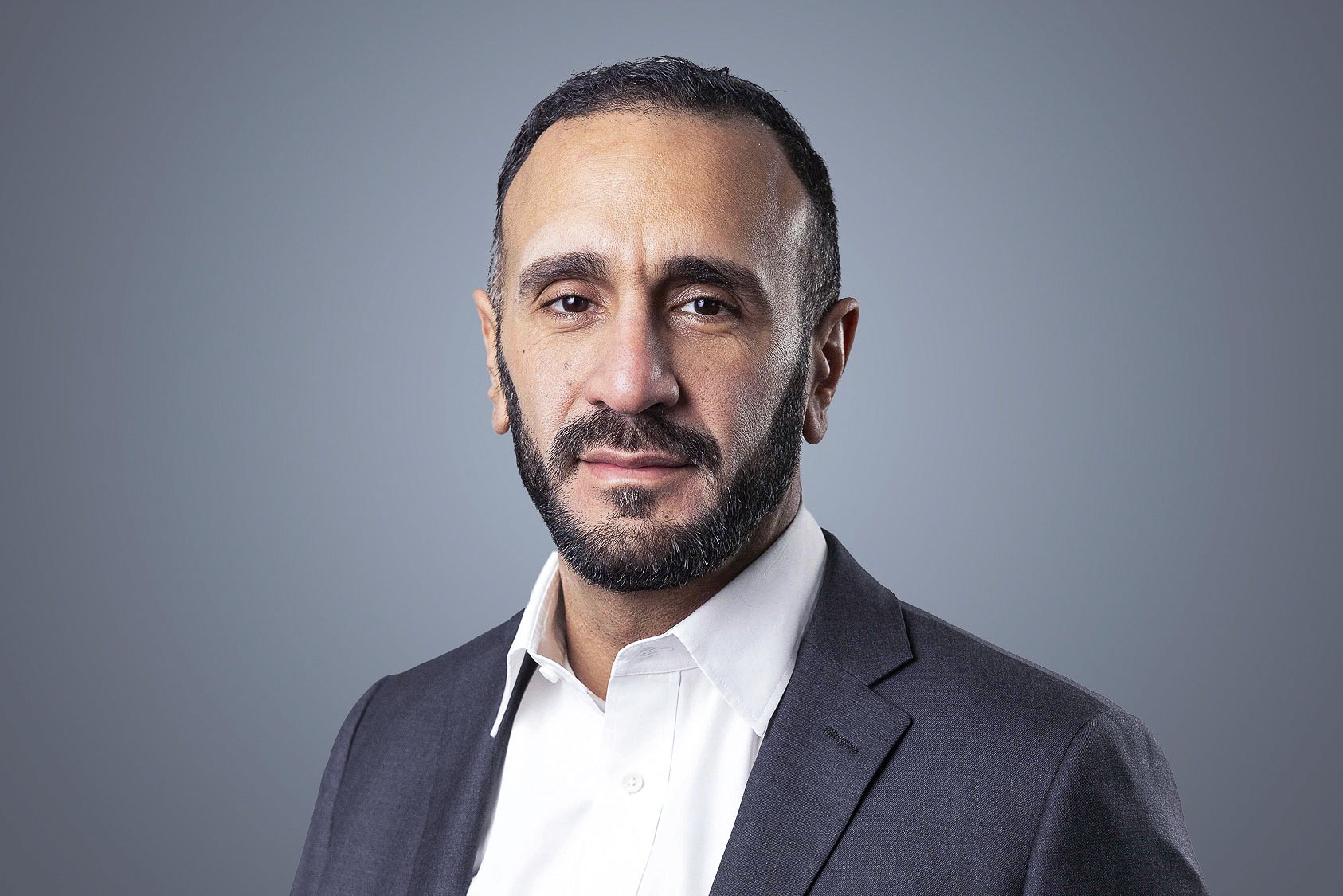 Hamed Ghanei, SteriMax EVP, Innovation: Smiling in professional business attire against a neutral studio background.