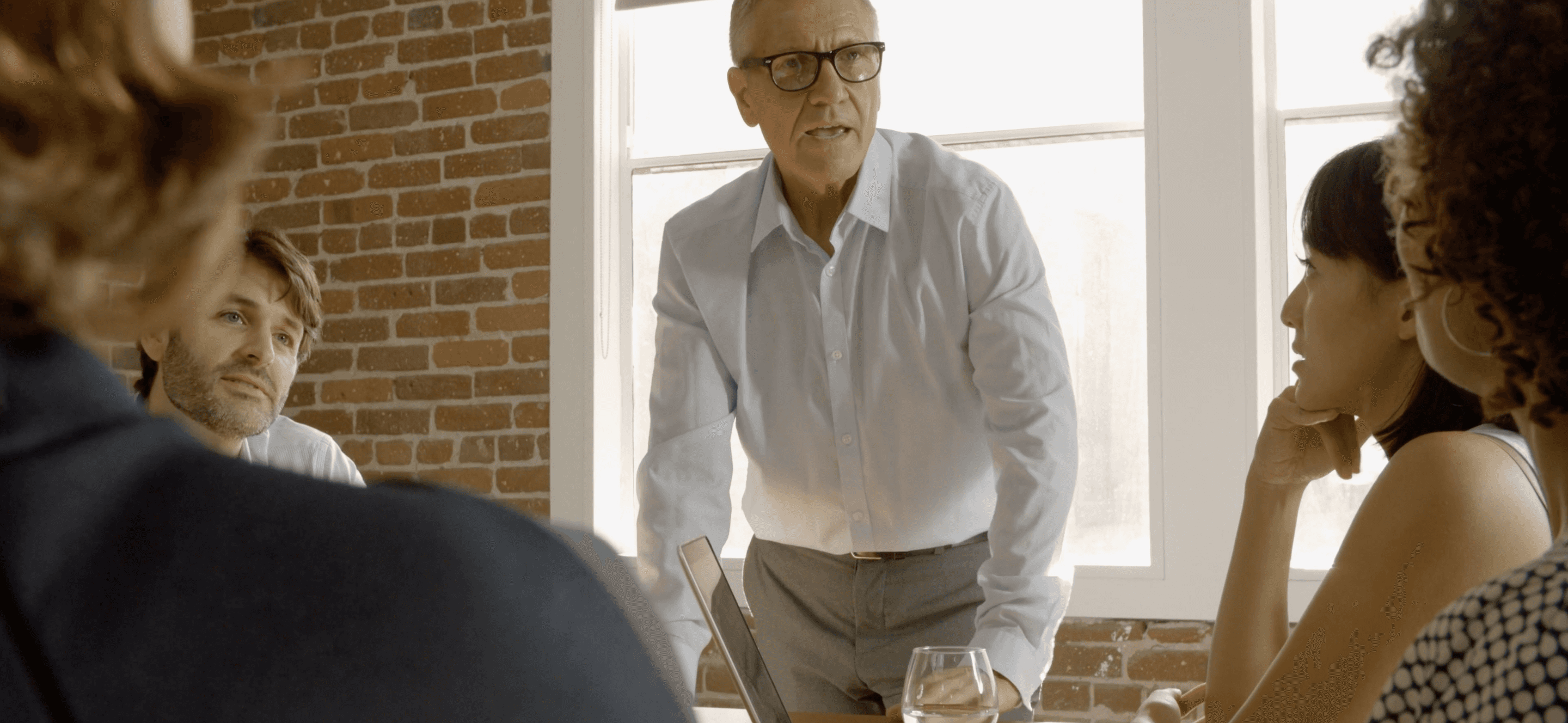 A medioum-size family business having a discussion around the boardroom table.