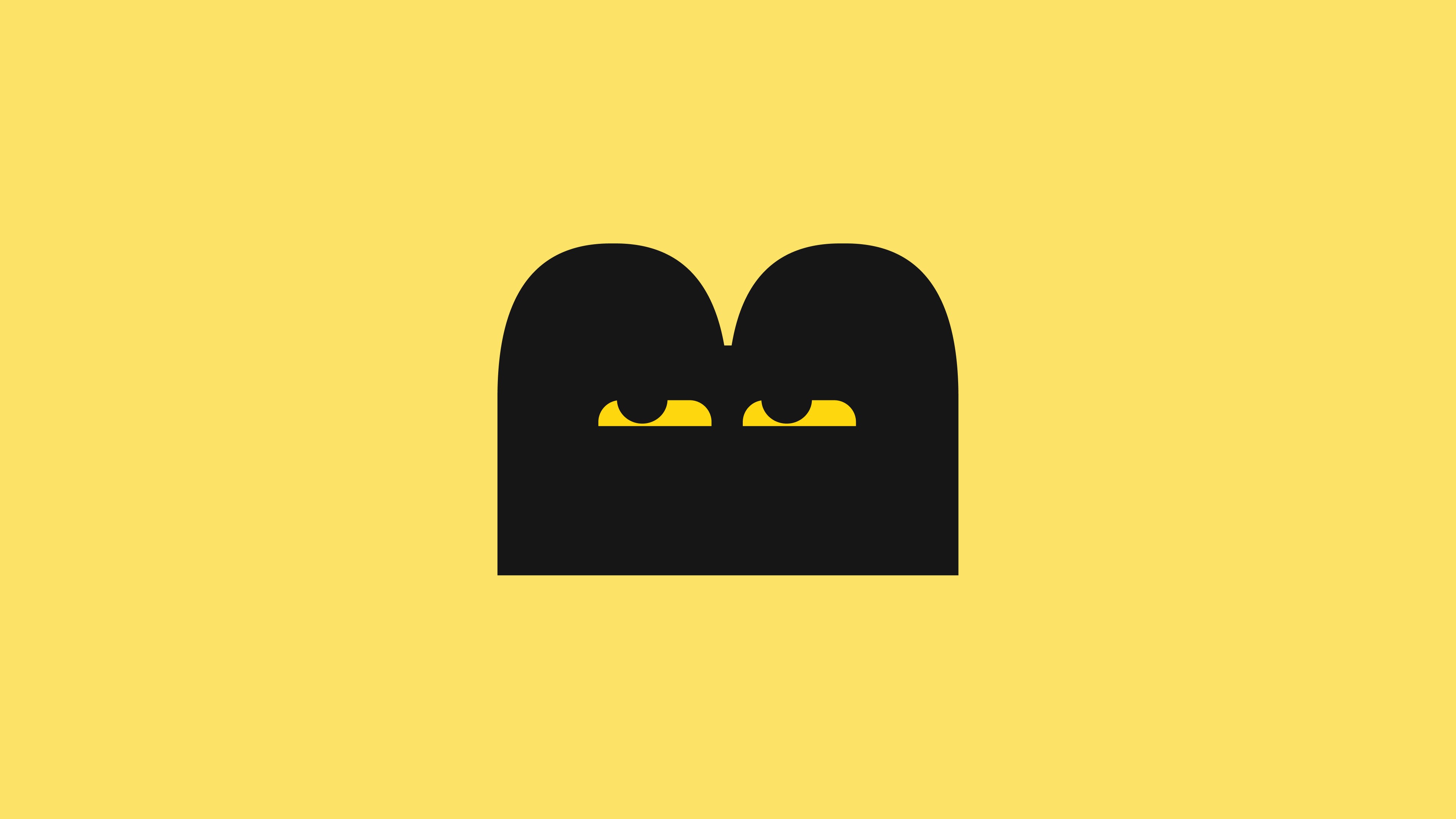Logomark of a block on yellow bg