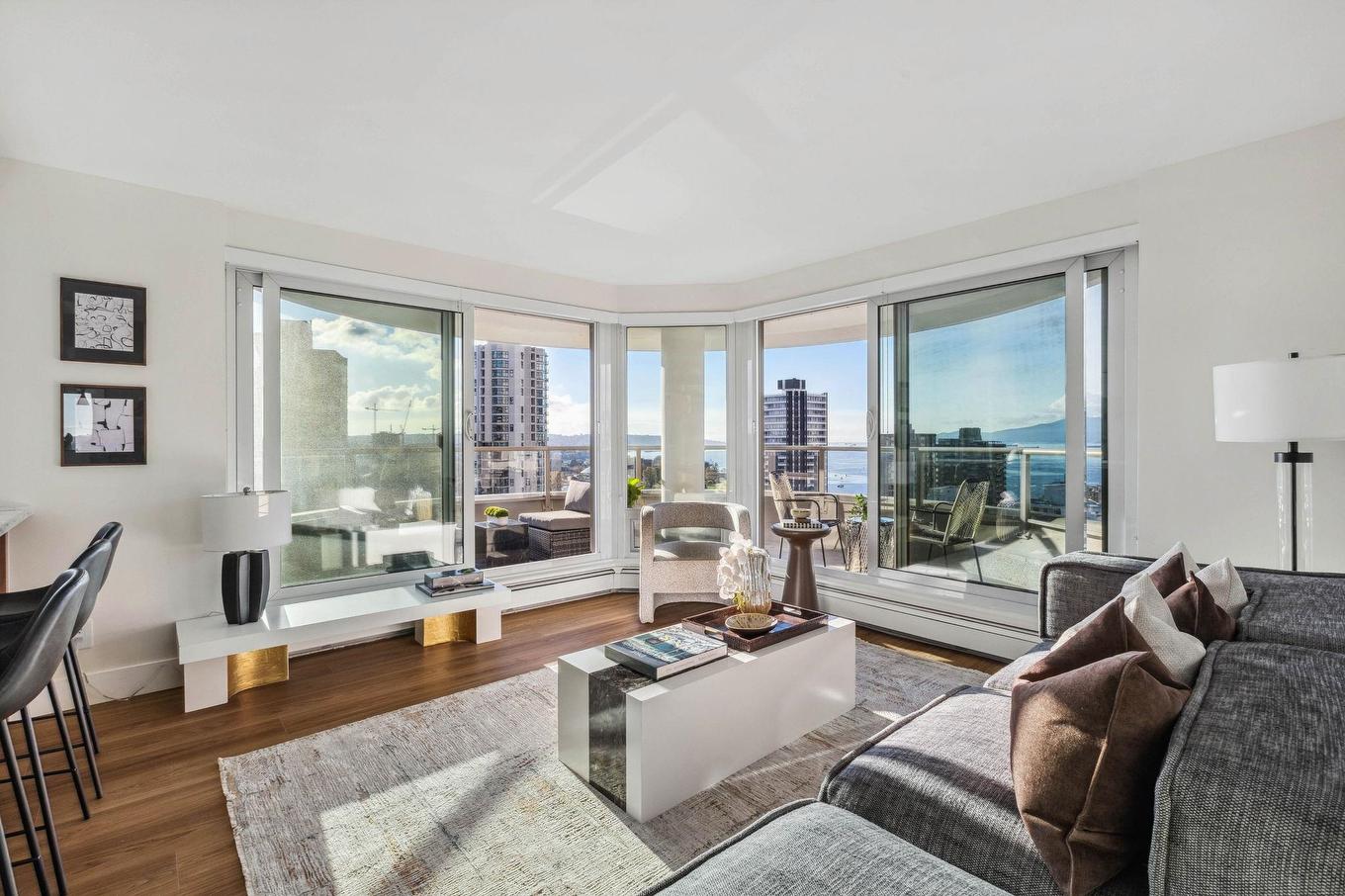 Bright modern living room with large windows, sleek furniture, and neutral tones, showcasing a spacious, inviting atmosphere.