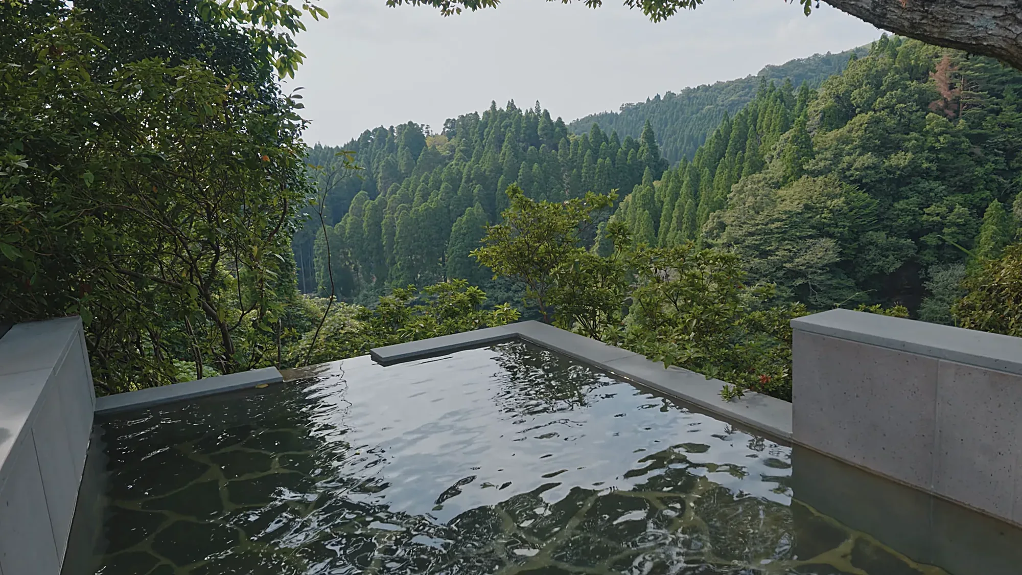 An infinity-edge bath looking out over the valley at Kurokawa Onsen