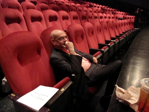 a man sitting in a red chair in the amphitheater