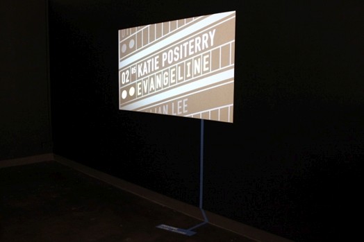 an image projected on the wall with the name Katie Positerry