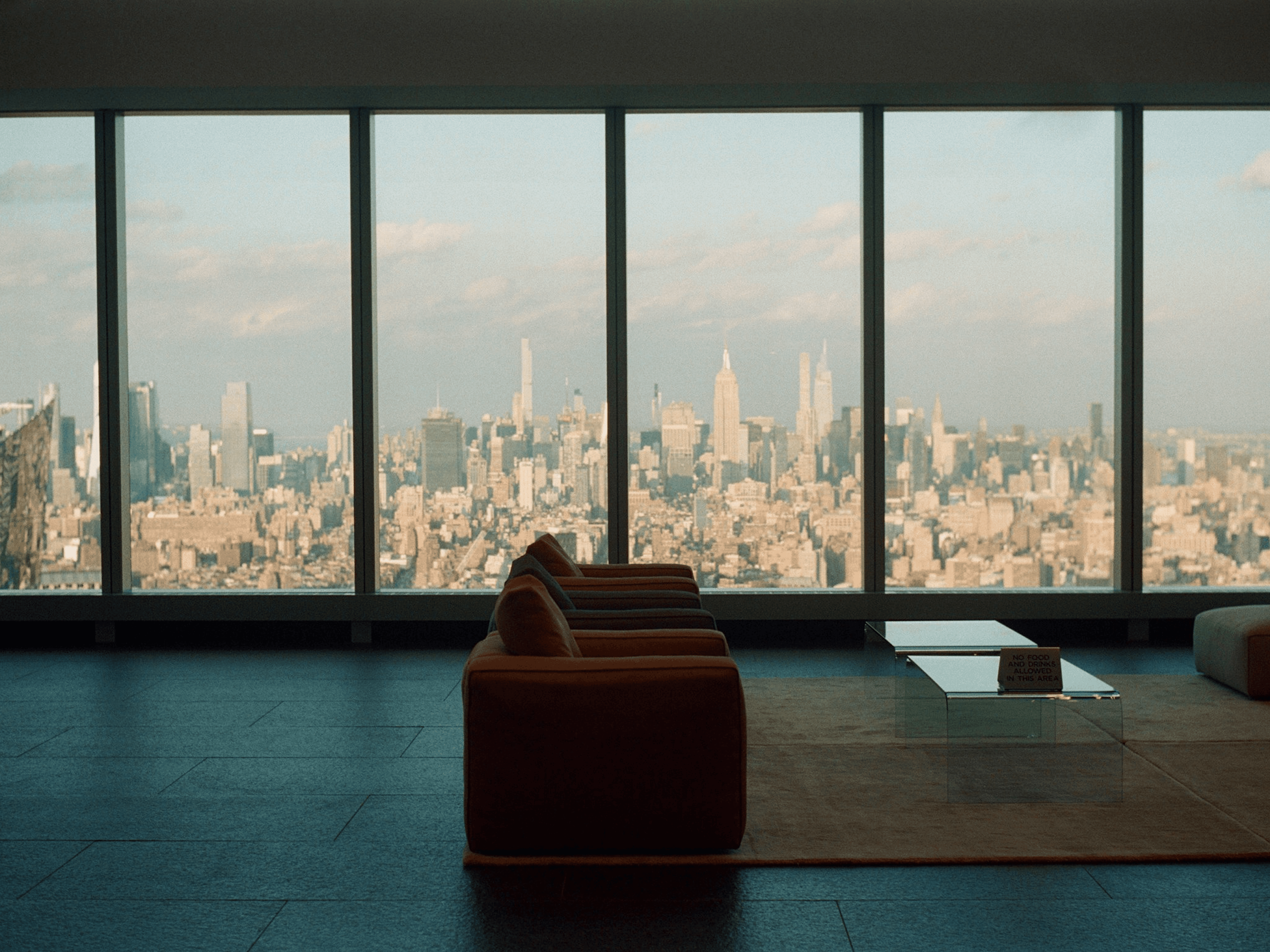 brown wooden bench near window