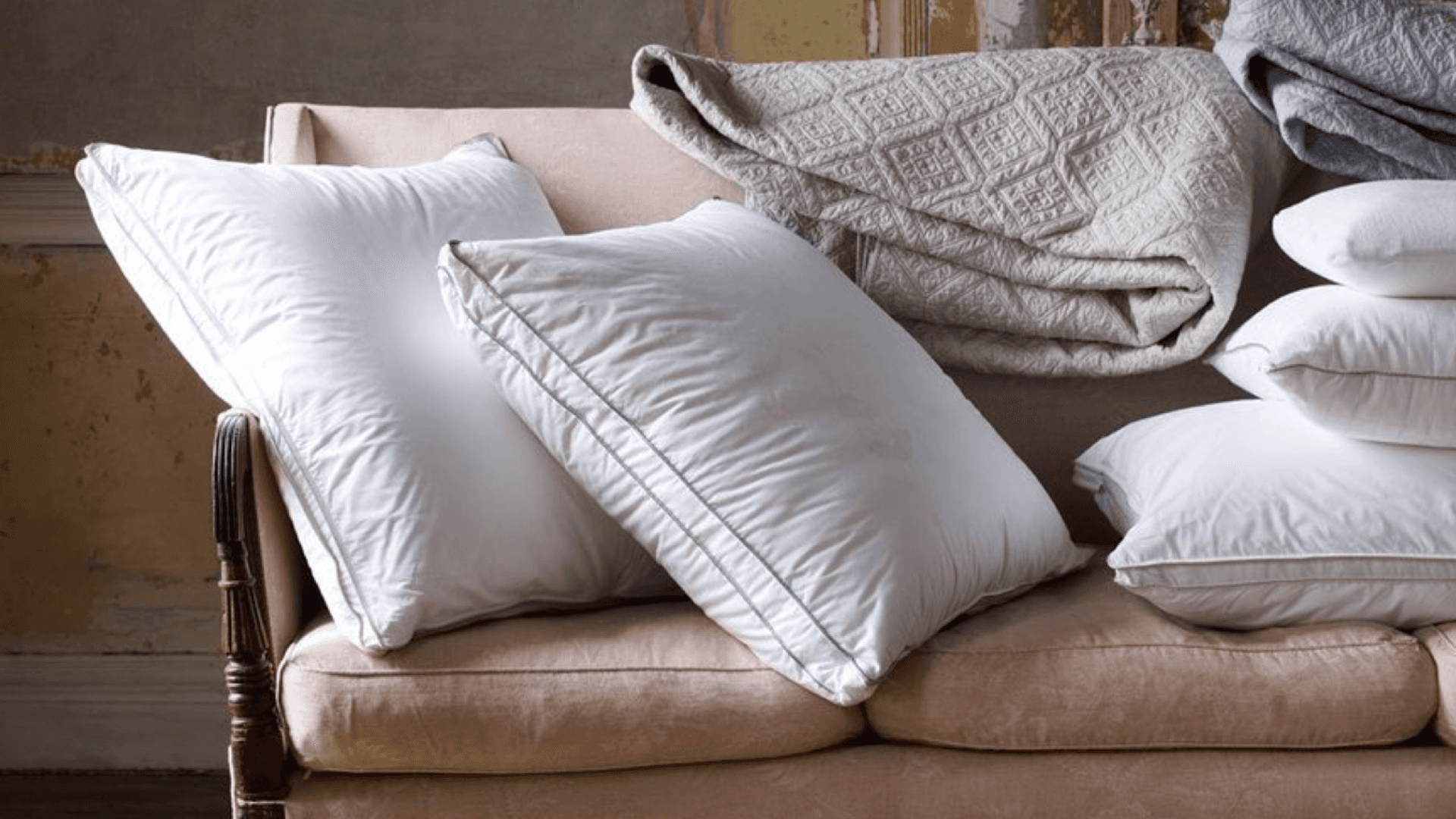 A couch covered in cushions and throws