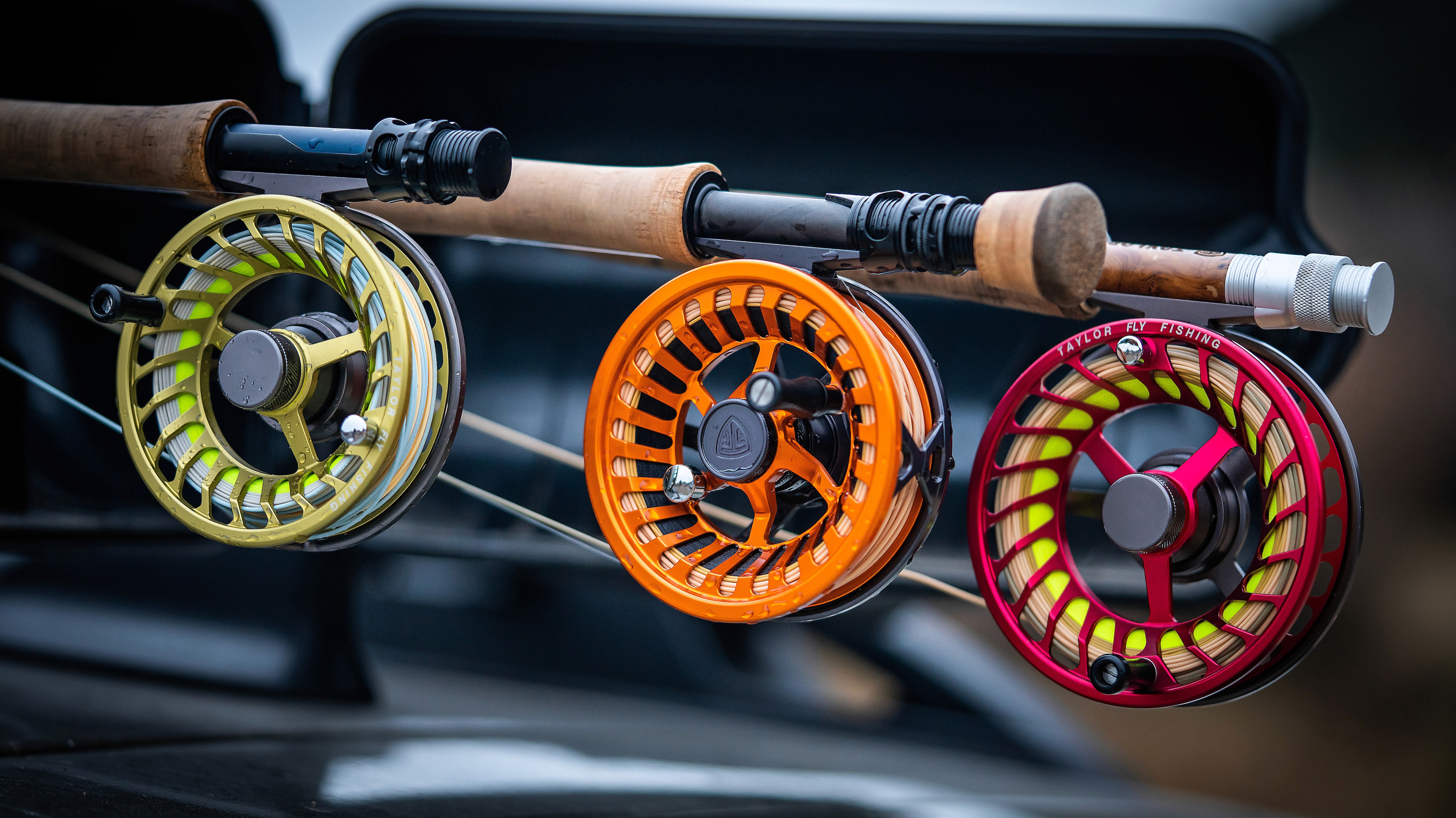 orange fly fishing reel, red fly fishing reel, green fly fishing reel