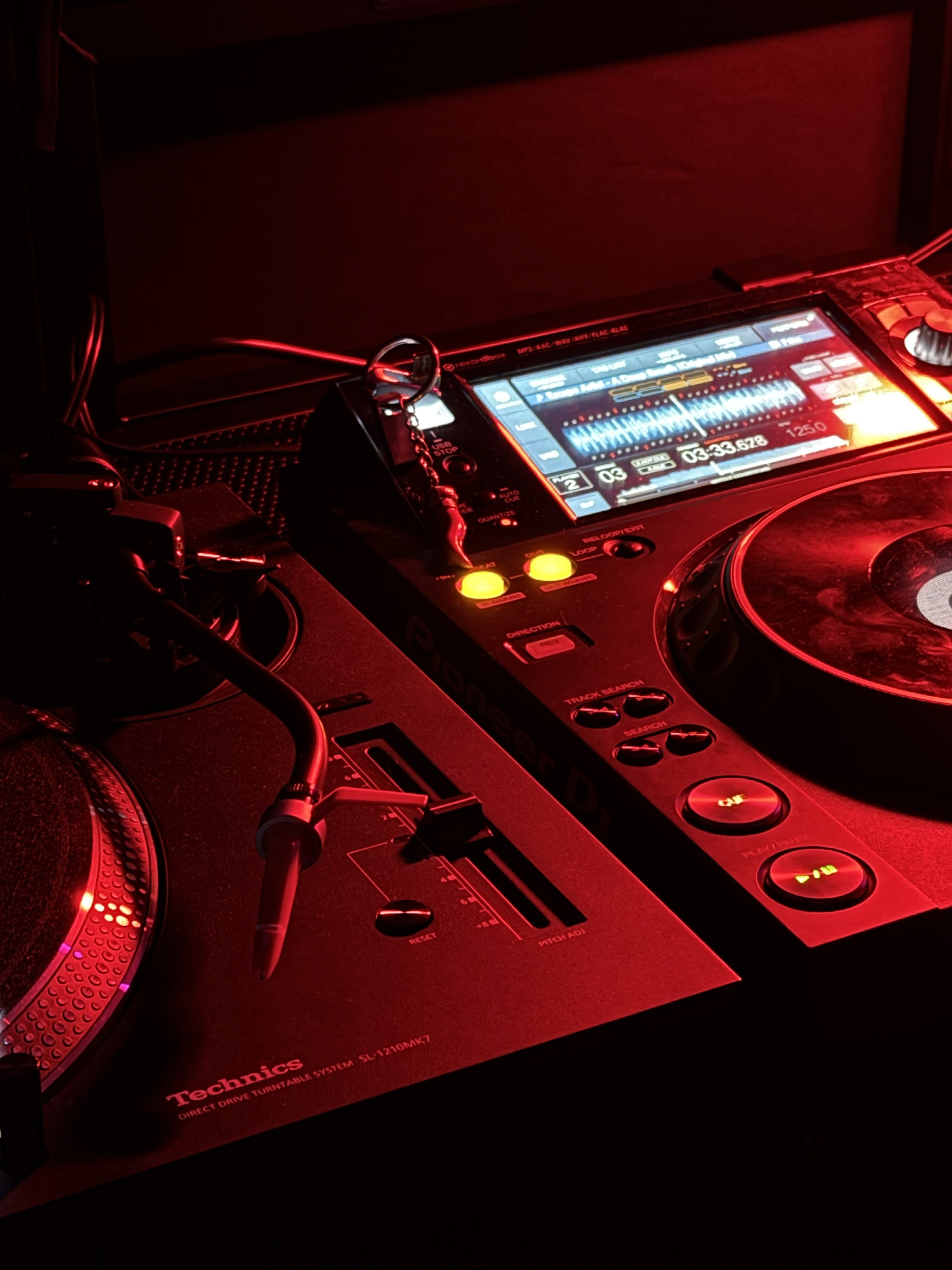 A crowd of people at a concert with their hands in the air