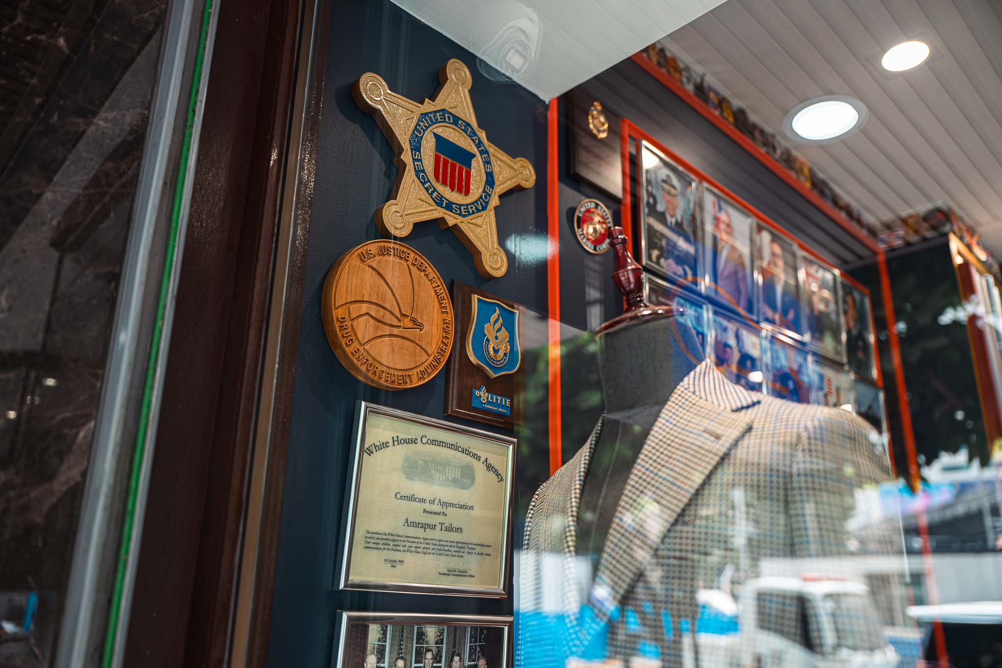 Four men in olive shirts and tan pants working together.