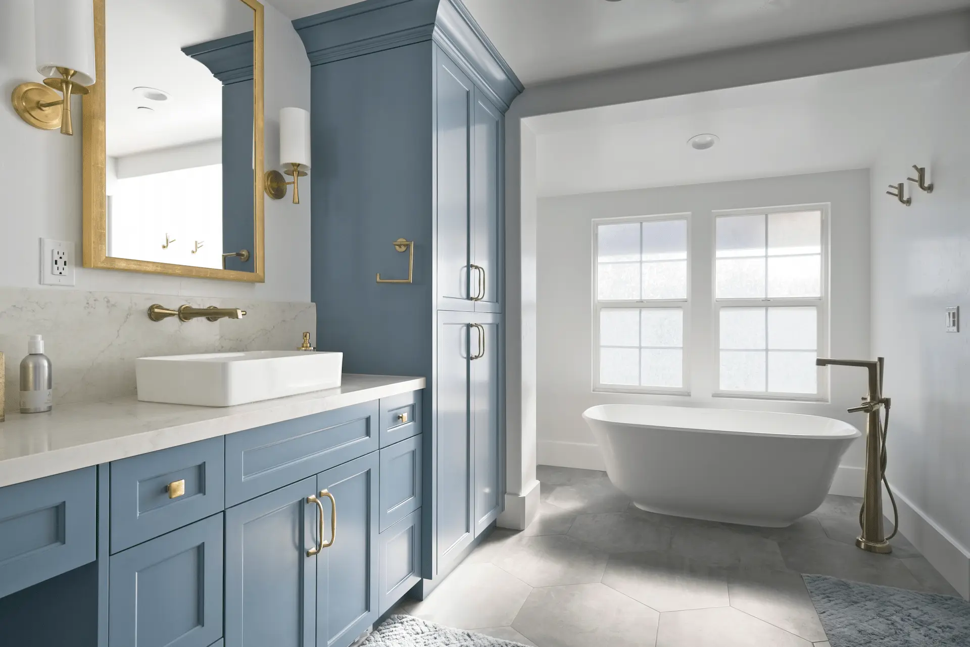 Wide angle shot of the primary bathroom, displaying the elegant vanity and free-standing tub, epitomizing luxury in the Ladera Ranch Remodel. Photo by Todd Huge.