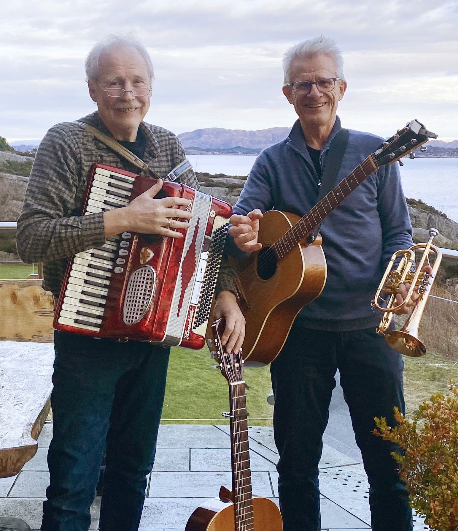 Two guys in their prime holding instruments and ready to play for you