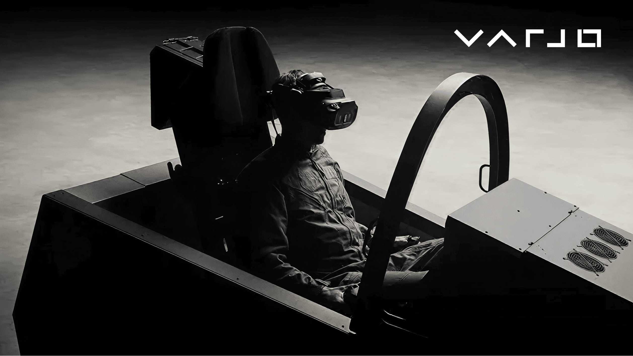 A pilot seated in a professional flight simulator cockpit wearing a high-fidelity Varjo XR-4 headset, demonstrating enterprise-grade virtual reality usage for simulation and training.