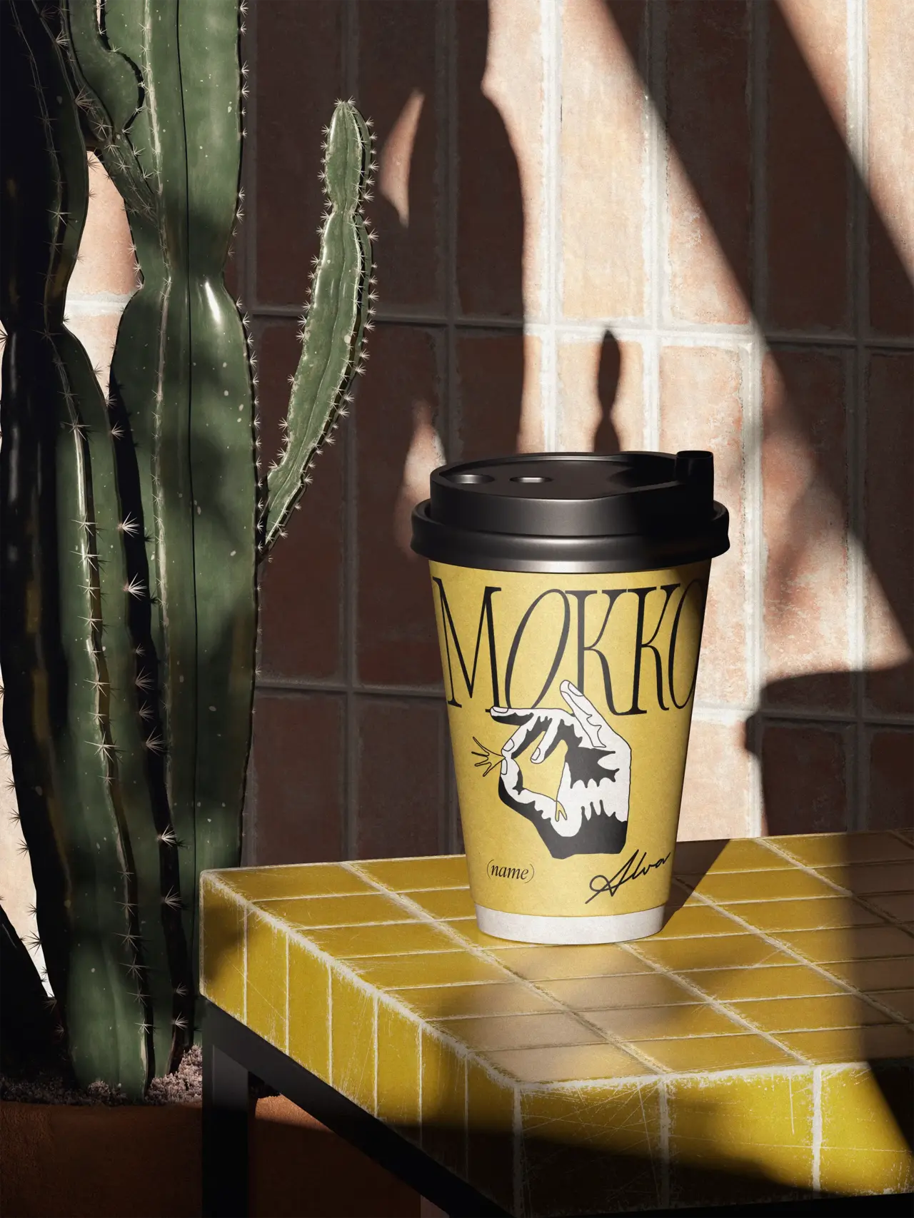 Yellow coffee cup beside a cactus on a yellow tiled table.