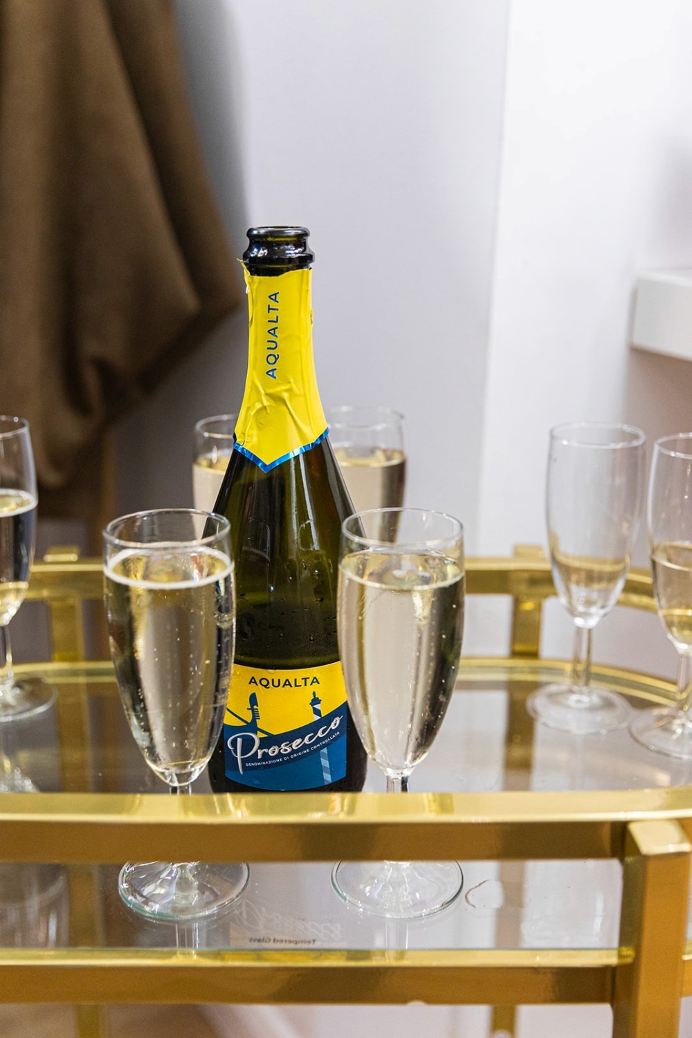 Champagne glasses filled with bubbly in a bright studio space.